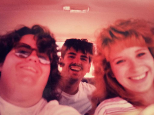 Drei Personen, die jemanden anschauen und lachen