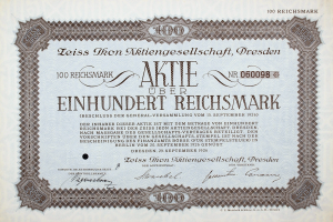 Ein altes deutsches Aktienzertifikat mit schwarzem Rand, auf dem der Text "Aktie über Einhundert Reichmark" steht