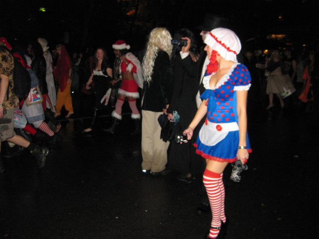 Eine Gruppe von Menschen, einige in Dramakostümen, gehen über einen Boden.