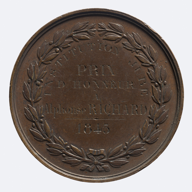 Bronze-Medaille mit Lorbeerkranz-Design, mit eingravierter Beschriftung, vor einem weißen Hintergrund.